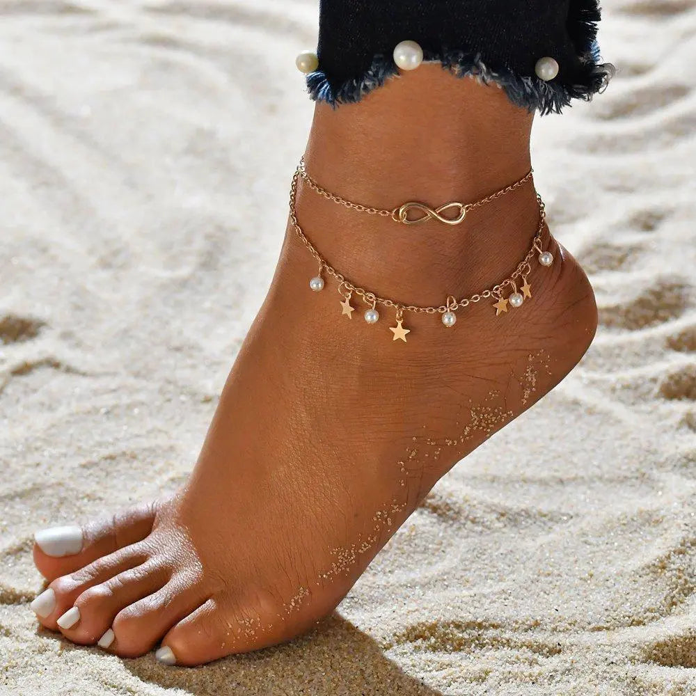 Cavigliera elegante con pendenti a infinito, perla e stella