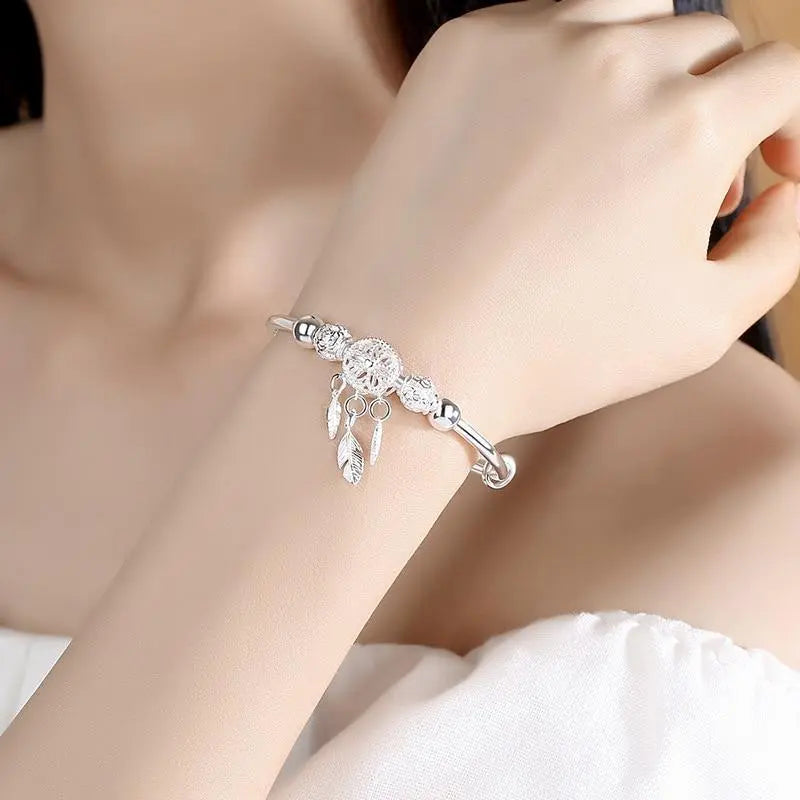 Bracelet à breloques capteur de rêves en argent